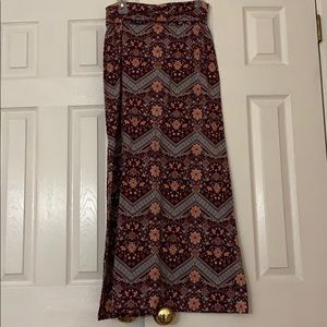 Long skirt, background is maroon color.